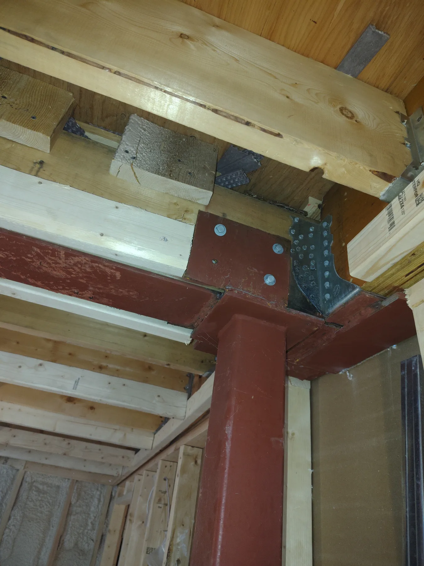 Custom steel connection plate at a structural junction